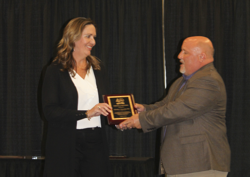This photograph shows Dr. Sheli Reynolds receiving a plaque in commemoration of her Friend of MACDDS Award.